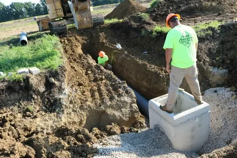 underground utility installation trenching process with excavator